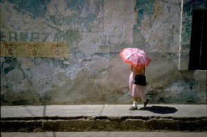 Woman with umbrella walking in Alamos, Sonora, Mexico. Photo by Anders Tomlinson.